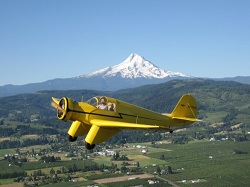 WAAAM's Aeronca LC flying by Mount Hood.