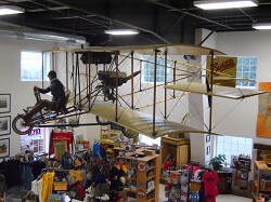 WAAAM's Curtiss Pusher based on the 1912 style hangs above the museum's gift shop.