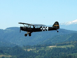 WAAAM's WWII Piper L-4A flying during a Second Saturday event.