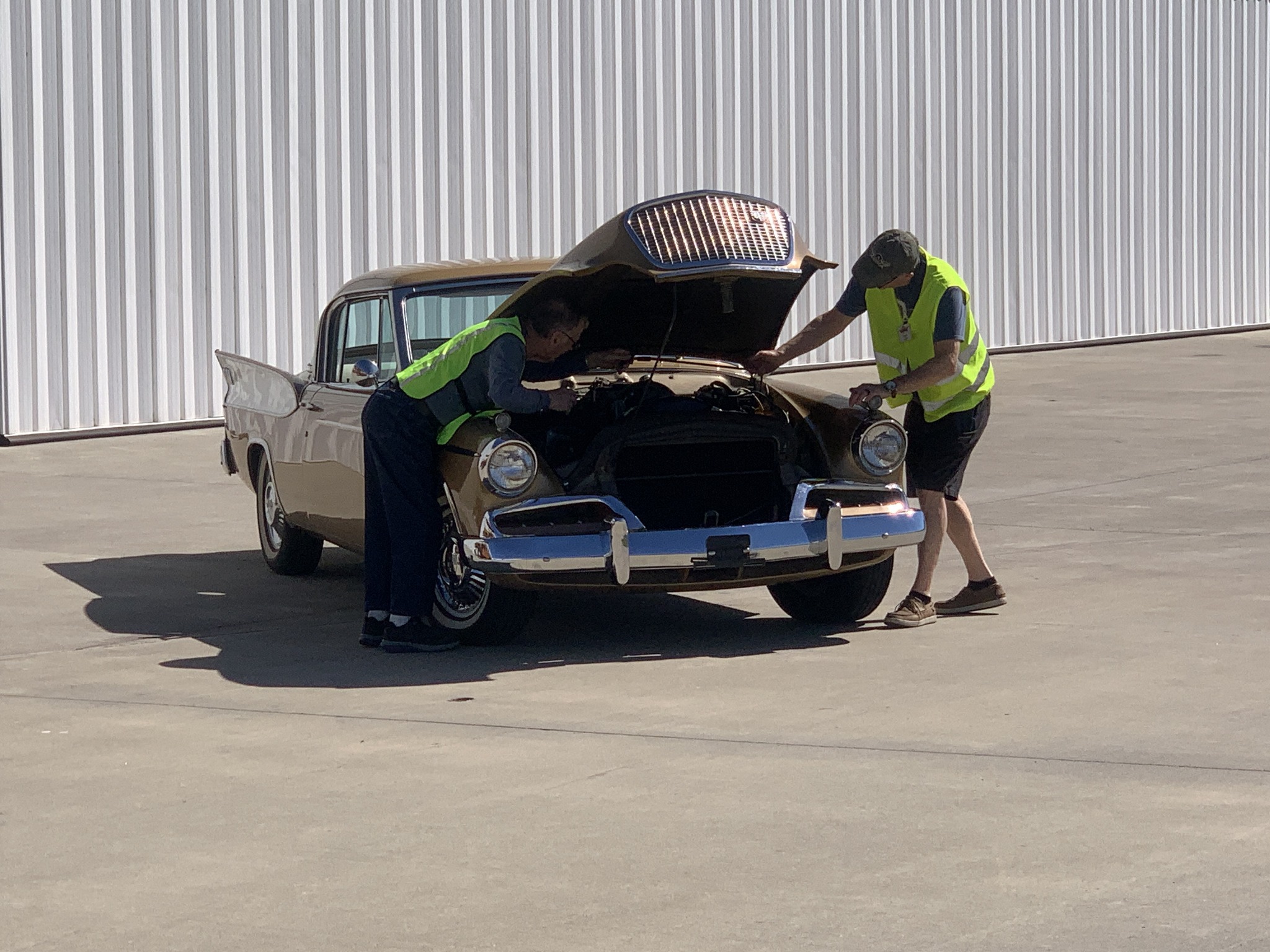 volunteers-working-on-an-antique-car